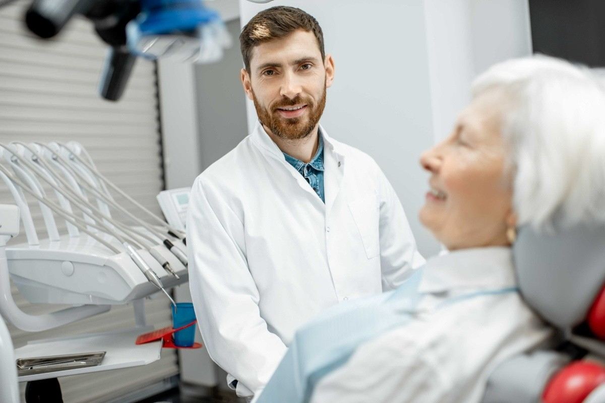 Dentist discussing Invisalign treatment with a patient during a dental consultation